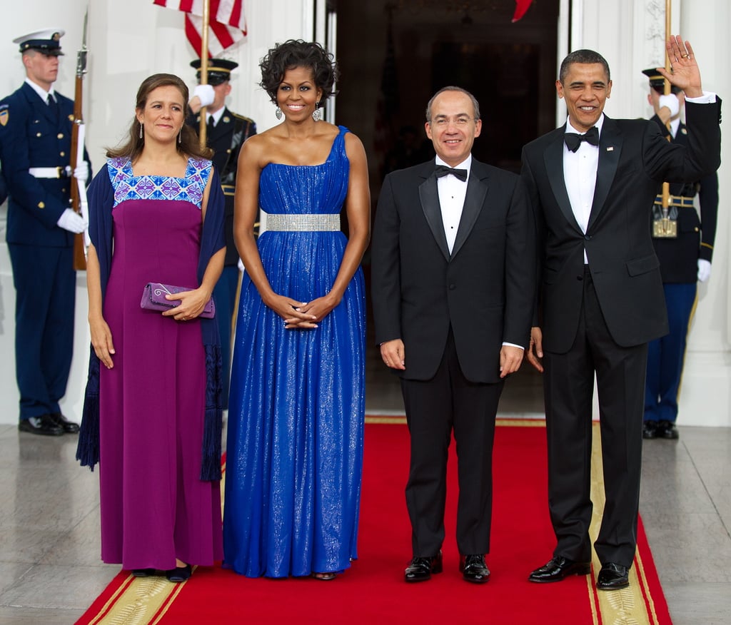 She’s electric in blue Peter Soronen. The one-shoulder silhouette proves why Michelle Obama is the most fashion-conscious First Lady since Jackie O.